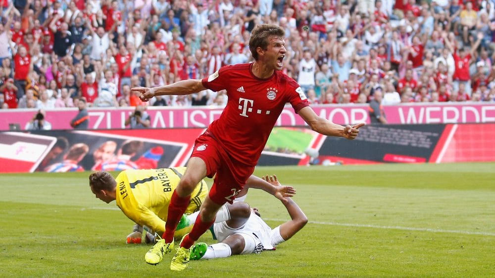 MUNICH, GERMANY - AUGUST 29: Thomas Mueller (C) of Muenchen celebrates after scoring his team's first goal during the Bundesliga match between FC Bayern Muenchen and Bayer 04 Leverkusen at Allianz Arena on August 29, 2015 in Munich, Germany. (Photo by Boris Streubel/Bongarts/Getty Images)