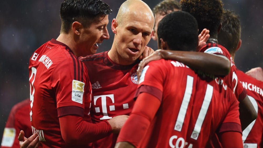 Robert Lewandowski of Bayern Munich (L) celebrates with team mates as he scores their first goal during the Bundesliga match between FC Bayern Muenchen and 1899 Hoffenheim at Allianz Arena on January 31, 2016 in Munich, Germany.