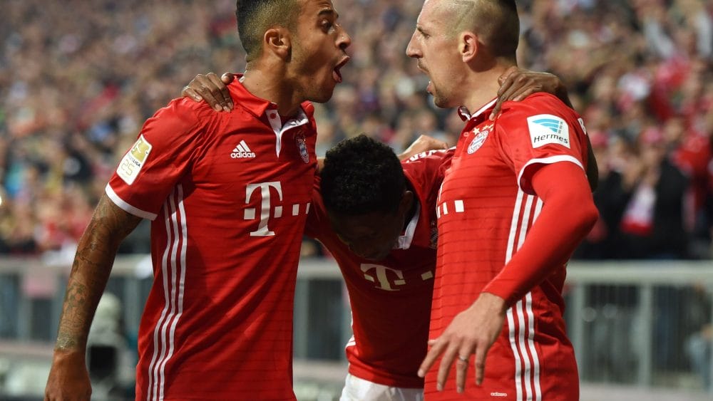 (L-R) Bayern Munich's Spanish midfielder Thiago Alcantara, Bayern Munich's Austrian defender David Alaba and Bayern Munich's French midfielder Franck Ribery celebrate after the opening goal during the German first division Bundesliga football match between FC Bayern Munich and Hertha Berlin in Munich, southern Germany, on September 21, 2016. / AFP / CHRISTOF STACHE