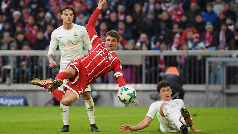 MUNICH, GERMANY - JANUARY 21: Thomas Mueller of FC Bayern Muenchen scores his team's first goal during the Bundesliga match between FC Bayern Muenchen and SV Werder Bremen at Allianz Arena on January 21, 2018 in Munich, Germany. (Photo by Matthias Hangst/Bongarts/Getty Images)