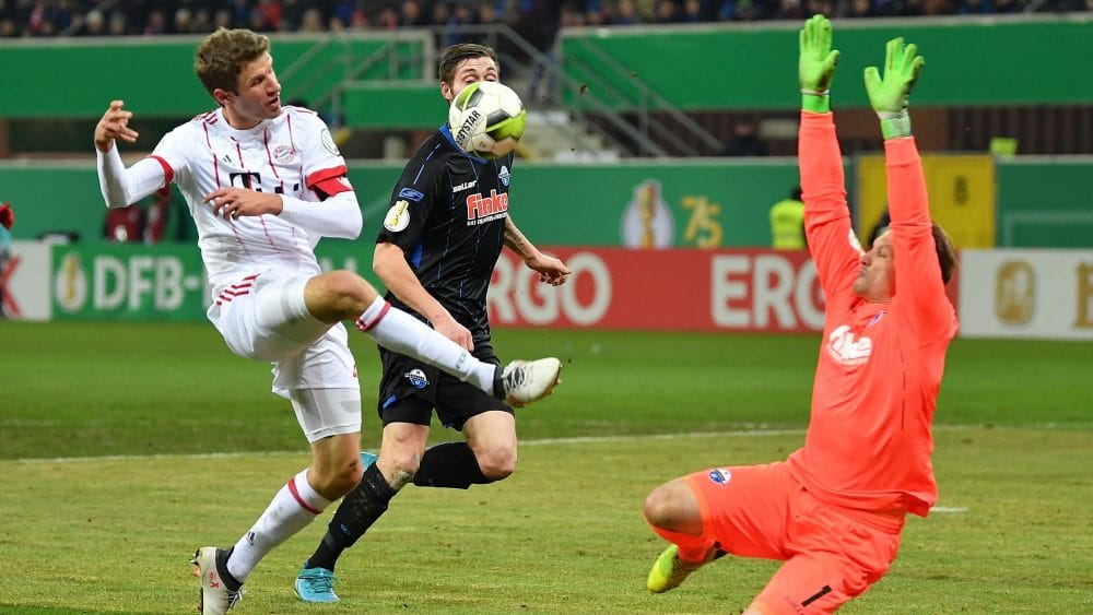 PADERBORN, GERMANY - FEBRUARY 06: Thomas Mller of Muenchen is challenged by Michael Ratajczak of Bielefeld during the DFB Pokal quater final match between SC Paderborn and Bayern Muenchen at Benteler Arena on February 6, 2018 in Paderborn, Germany. (Photo by Stuart Franklin/Bongarts/Getty Images)