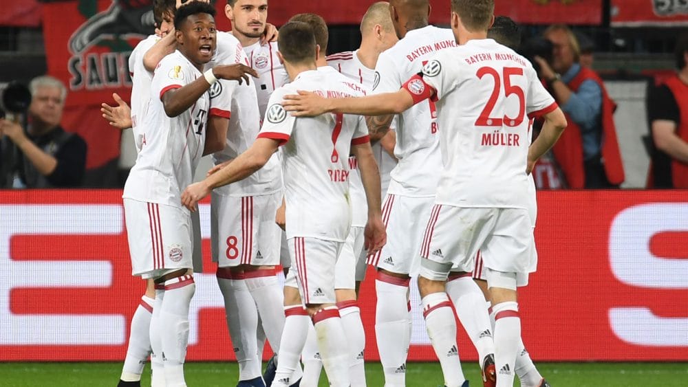 Munich's players celebrate after scoring during the German football Cup DFB Pokal semifinal match Bayer 04 Leverkusen vs Bayern Munich in Leverkusen, western Germany, on April 17, 2018. / AFP PHOTO / Patrik STOLLARZ