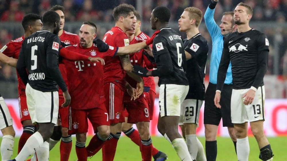 MUNICH, GERMANY - DECEMBER 19: Stefan Ilsanker of RB Leipzig is shown a red card from the referee as the Bayern Munich and RB Lepzig players clash during the Bundesliga match between FC Bayern Muenchen and RB Leipzig at Allianz Arena on December 19, 2018 in Munich, Germany. (Photo by Alexander Hassenstein/Bongarts/Getty Images)