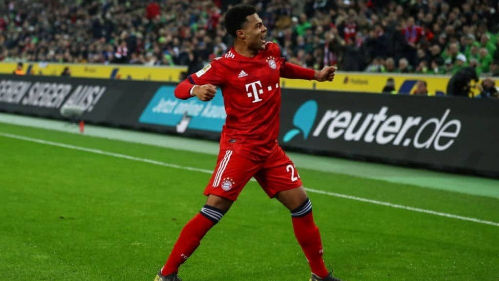 MOENCHENGLADBACH, GERMANY - MARCH 02: Serge Gnabry #22 of Bayern Munich celebrates scoring his sides fourth goal during the Bundesliga match between Borussia Moenchengladbach and FC Bayern Muenchen at Borussia-Park on March 02, 2019 in Moenchengladbach, Germany.