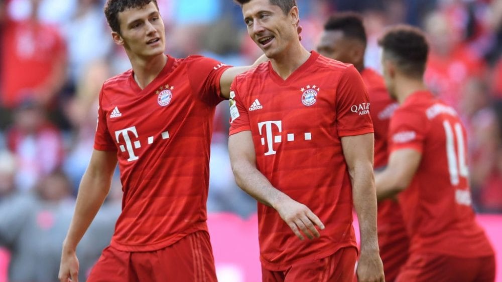 Bayern Munich's French defender Benjamin Pavard (L) and Bayern Munich's Polish striker Robert Lewandowski (R) react after the second goal for Munich during the German first division Bundesliga football match FC Bayern Munich vs 1. FC Cologne in Munich on September 21, 2019. (Photo by Christof STACHE / AFP) (Photo credit should read CHRISTOF STACHE/AFP/Getty Images)